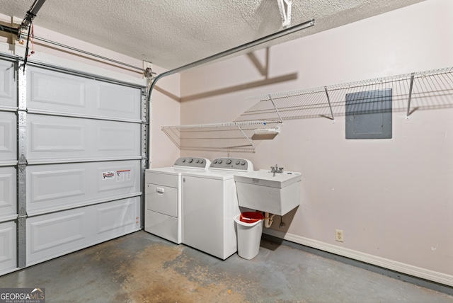 107 Linkside Dr, Saint Simons, GA 31522 - washroom featuring washing machine and clothes dryer, a garage, baseboards, and a textured ceiling