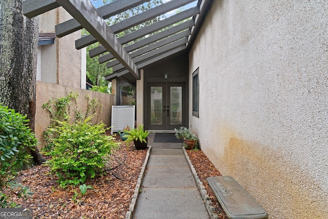 107 Linkside Dr, Saint Simons, GA 31522 - entrance to property with french doors, stucco siding, and a pergola
