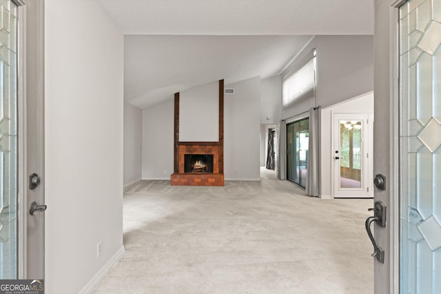107 Linkside Dr, Saint Simons, GA 31522 - entrance foyer with light colored carpet, a fireplace, baseboards, and vaulted ceiling
