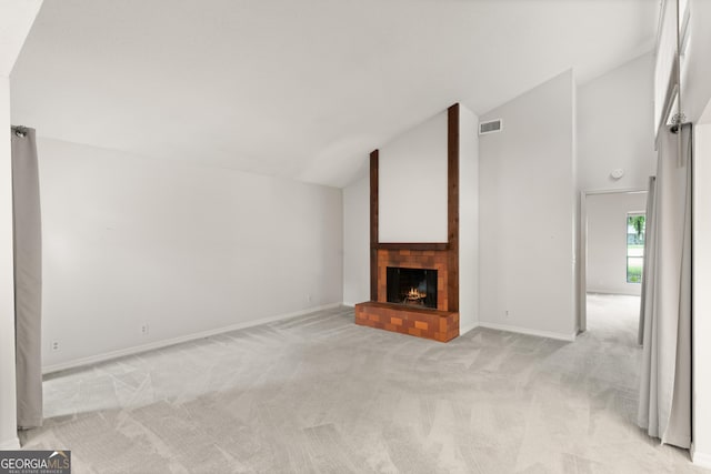 107 Linkside Dr, Saint Simons, GA 31522 - unfurnished living room with lofted ceiling, light carpet, a fireplace, and baseboards