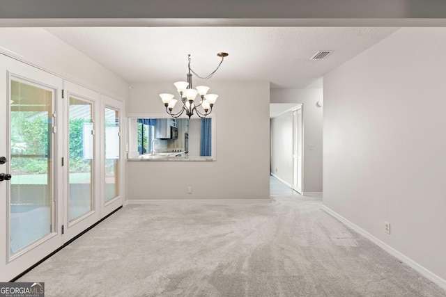 107 Linkside Dr, Saint Simons, GA 31522 - unfurnished dining area featuring a chandelier, carpet floors, baseboards, and a sink