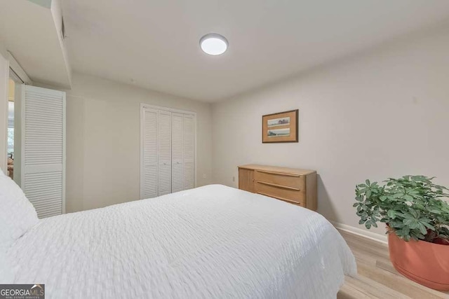 1111 Clairemont Ave Unit N3, Decatur, GA 30030 - bedroom featuring baseboards, light wood-style flooring, and a closet