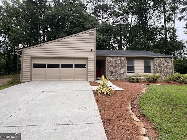 2786 Olde Gate Ct, Snellville, GA 30078 - mid-century modern home featuring stone siding, concrete driveway, and a garage