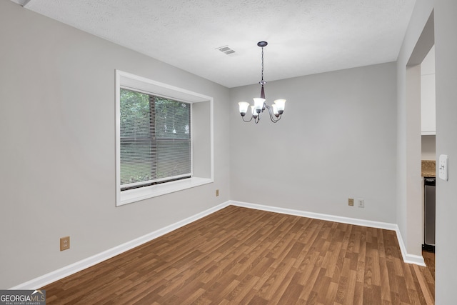 2786 Olde Gate Ct, Snellville, GA 30078 - spare room featuring wood finished floors, a chandelier, baseboards, and a textured ceiling