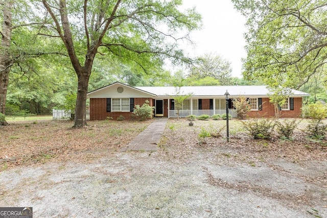 701 Log Landing Rd, Springfield, GA 31329 - ranch-style house featuring a porch and brick siding