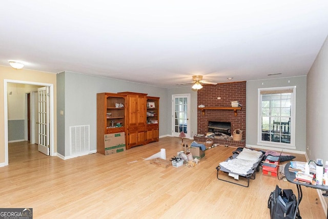 701 Log Landing Rd, Springfield, GA 31329 - living area with a fireplace, ceiling fan, wood finished floors, and baseboards