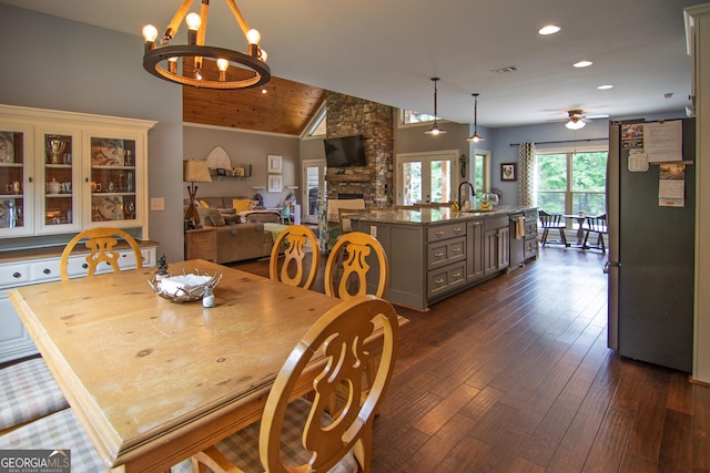 299 Savior Ln, Hamilton, GA 31811 - dining area with dark wood-style floors, recessed lighting, a chandelier, ceiling fan, and a stone fireplace