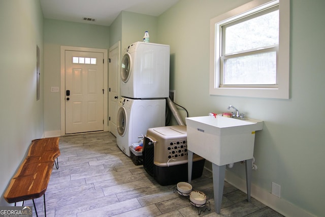 299 Savior Ln, Hamilton, GA 31811 - laundry area with stacked washing machine and dryer and light wood-type flooring