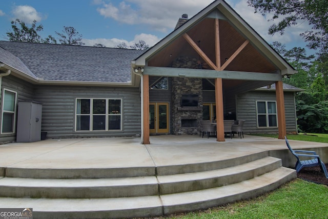 299 Savior Ln, Hamilton, GA 31811 - back of house with an outdoor stone fireplace, a patio, french doors, roof with shingles, and stone siding