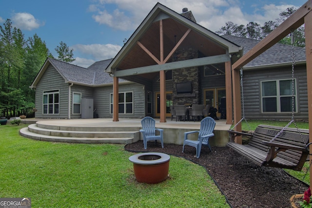 299 Savior Ln, Hamilton, GA 31811 - back of property featuring a fire pit, a lawn, and a shingled roof