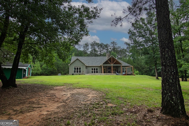 299 Savior Ln, Hamilton, GA 31811 - back of house featuring a yard, an outdoor structure, and a chimney