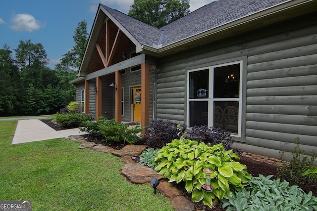 299 Savior Ln, Hamilton, GA 31811 - view of home's exterior featuring a shingled roof, a lawn, and faux log siding