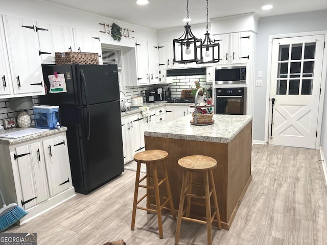 1 Trentwood Pl NW Unit A, Rome, GA 30165 - kitchen with oven, stainless steel microwave, freestanding refrigerator, backsplash, and light wood-type flooring