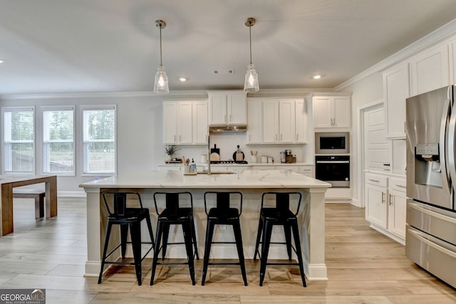 263 Blue Billed Xing, Jefferson, GA 30549 - kitchen with appliances with stainless steel finishes, crown molding, white cabinets, light countertops, and a kitchen bar