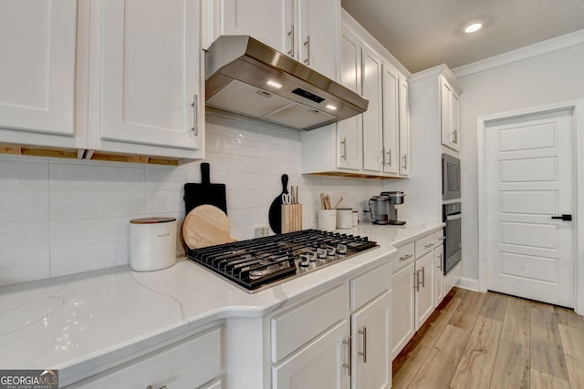 263 Blue Billed Xing, Jefferson, GA 30549 - kitchen featuring under cabinet range hood, stainless steel gas stovetop, white cabinets, black oven, and ornamental molding