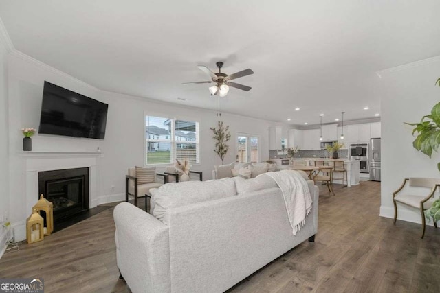 537 Garnet Dr, Acworth, GA 30101 - living room with a ceiling fan, crown molding, wood finished floors, recessed lighting, and a fireplace with flush hearth