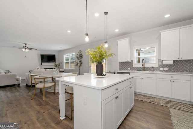 537 Garnet Dr, Acworth, GA 30101 - kitchen featuring a sink, open floor plan, decorative backsplash, a center island, and dark wood-type flooring