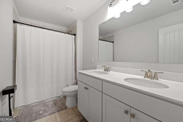 537 Garnet Dr, Acworth, GA 30101 - full bath featuring toilet, double vanity, and tile patterned flooring