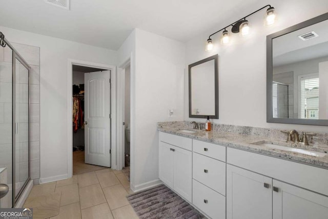 537 Garnet Dr, Acworth, GA 30101 - bathroom featuring a shower stall, double vanity, a spacious closet, and toilet