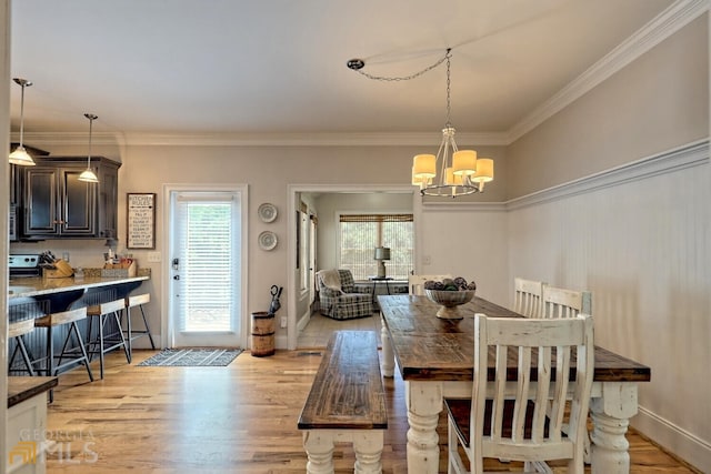 643 Washington St, Clarkesville, GA 30523 - dining space featuring a chandelier, light wood finished floors, ornamental molding, and baseboards