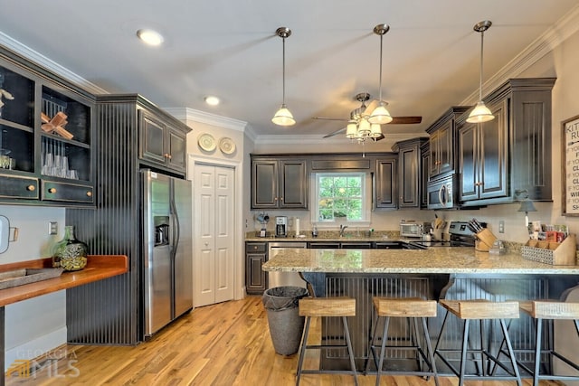 643 Washington St, Clarkesville, GA 30523 - kitchen featuring stainless steel appliances, crown molding, a peninsula, light stone countertops, and a sink