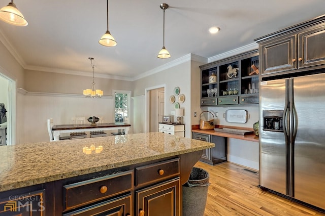 643 Washington St, Clarkesville, GA 30523 - kitchen featuring stainless steel fridge, a chandelier, light wood-type flooring, crown molding, and light stone counters
