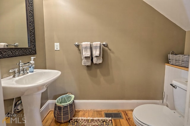 643 Washington St, Clarkesville, GA 30523 - half bath with toilet, wood finished floors, baseboards, and a sink