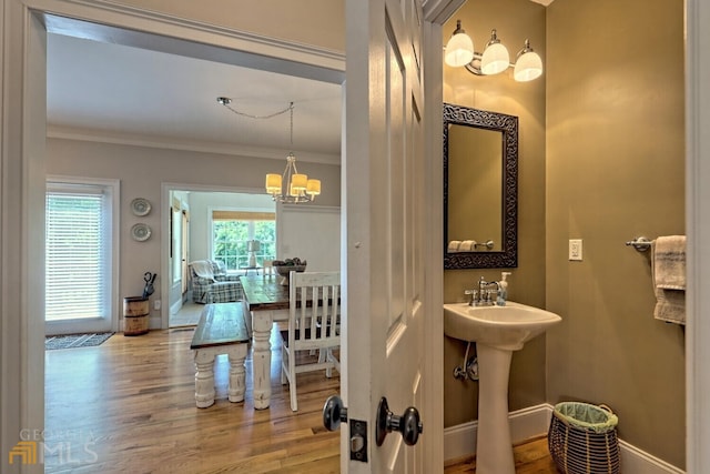 643 Washington St, Clarkesville, GA 30523 - bathroom featuring a chandelier, wood finished floors, crown molding, and baseboards