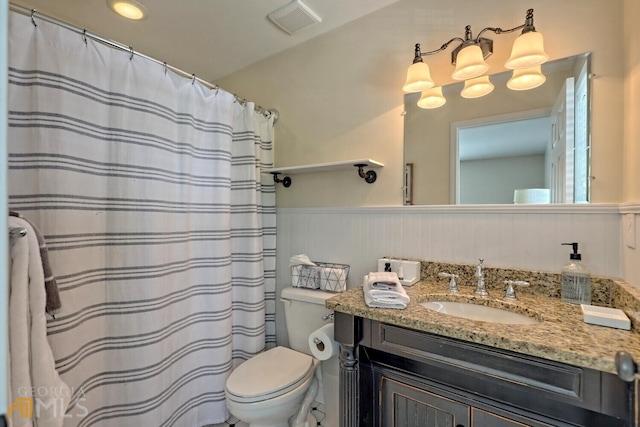 643 Washington St, Clarkesville, GA 30523 - full bathroom featuring wainscoting, toilet, vanity, and a shower with curtain
