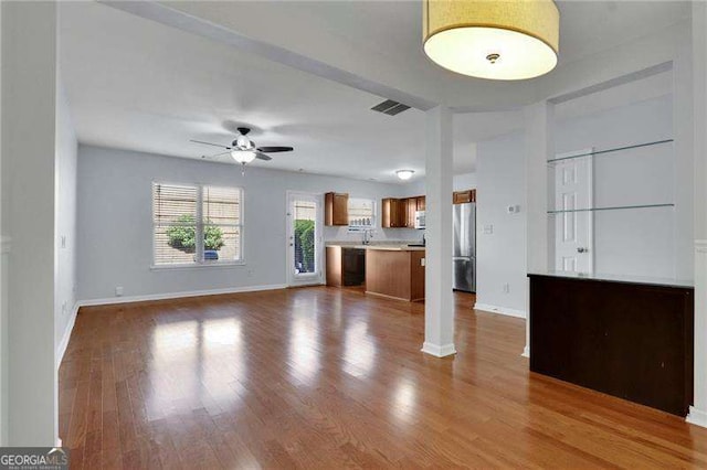 328 Oaktown Ct, Lawrenceville, GA 30044 - unfurnished living room featuring baseboards, a ceiling fan, and wood finished floors