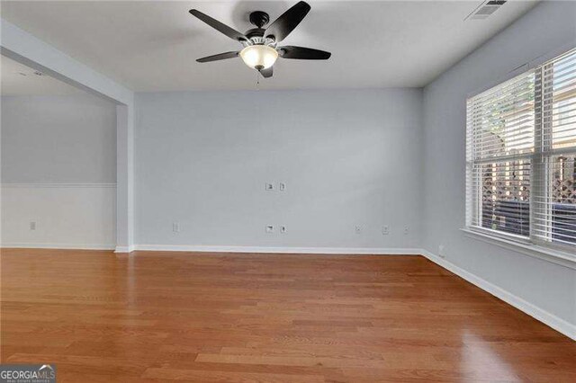 328 Oaktown Ct, Lawrenceville, GA 30044 - empty room with a ceiling fan, wood finished floors, and baseboards