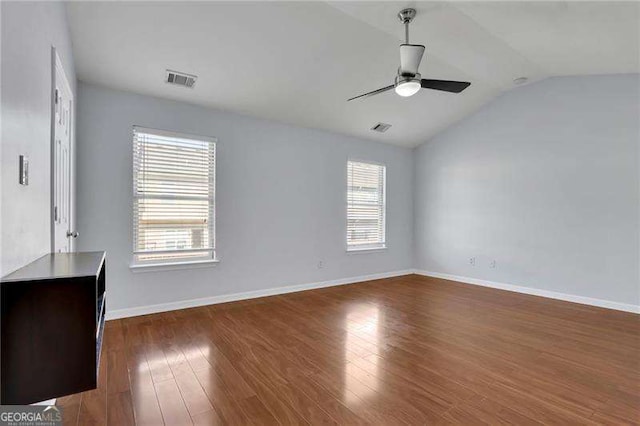 328 Oaktown Ct, Lawrenceville, GA 30044 - empty room with a ceiling fan, dark wood-type flooring, vaulted ceiling, and baseboards