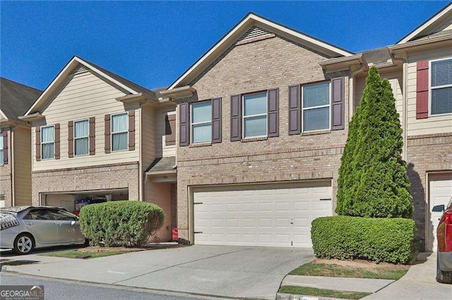 328 Oaktown Ct, Lawrenceville, GA 30044 - view of property with brick siding, an attached garage, and driveway