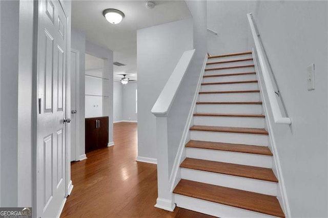 328 Oaktown Ct, Lawrenceville, GA 30044 - staircase featuring wood finished floors, ceiling fan, and baseboards