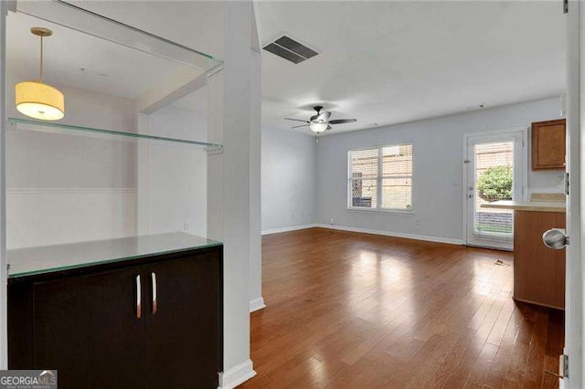 328 Oaktown Ct, Lawrenceville, GA 30044 - unfurnished living room with a ceiling fan, wood finished floors, and baseboards