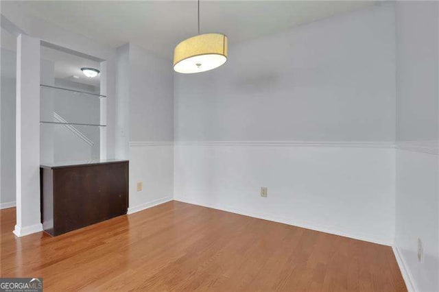 328 Oaktown Ct, Lawrenceville, GA 30044 - unfurnished dining area featuring wood finished floors and baseboards