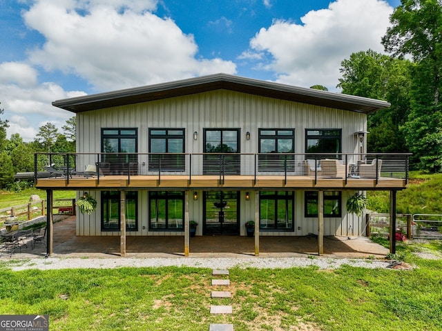 1971 Centennial Rd, Rutledge, GA 30663 - rear view of property featuring board and batten siding, a patio area, and a wooden deck