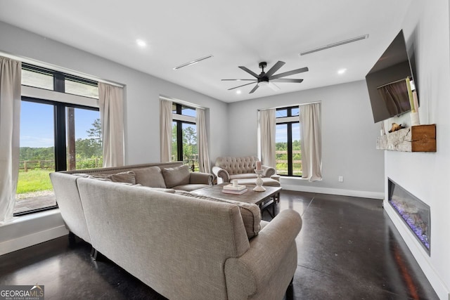 1971 Centennial Rd, Rutledge, GA 30663 - living area with healthy amount of natural light, baseboards, a glass covered fireplace, recessed lighting, and ceiling fan