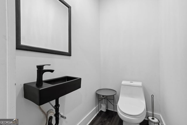 1971 Centennial Rd, Rutledge, GA 30663 - bathroom featuring baseboards, toilet, and wood finished floors