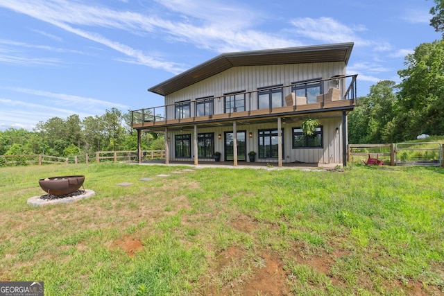 1971 Centennial Rd, Rutledge, GA 30663 - back of house featuring board and batten siding, a fire pit, and a deck