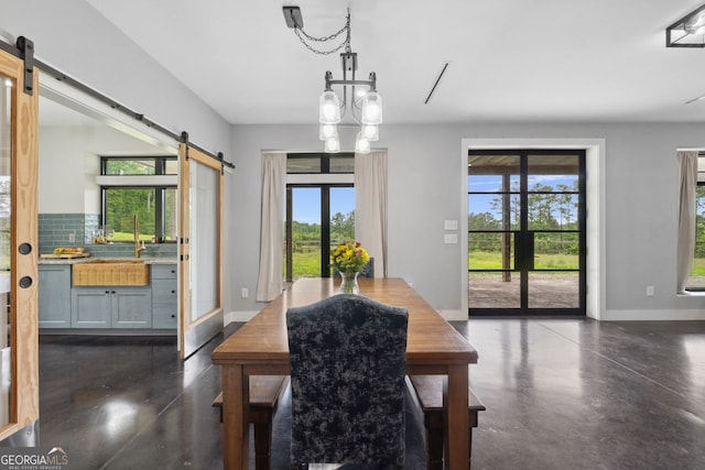 1971 Centennial Rd, Rutledge, GA 30663 - dining area featuring a barn door, concrete floors, and baseboards
