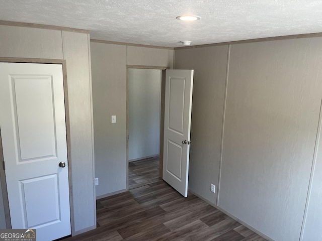 585 Elmer Thrift Rd, Waycross, GA 31503 - unfurnished bedroom featuring a textured ceiling and wood finished floors
