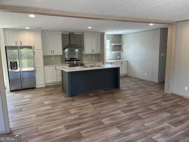 585 Elmer Thrift Rd, Waycross, GA 31503 - kitchen featuring stainless steel appliances, wall chimney range hood, a sink, recessed lighting, and wood finished floors