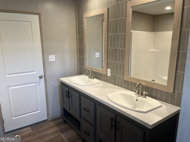 585 Elmer Thrift Rd, Waycross, GA 31503 - full bath with double vanity, wood finished floors, and tasteful backsplash