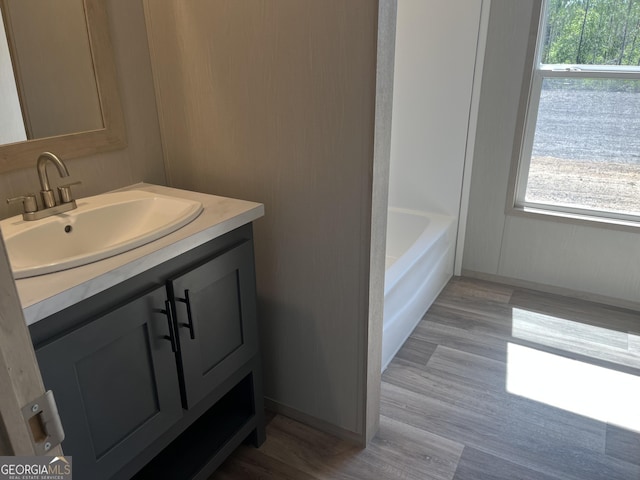 585 Elmer Thrift Rd, Waycross, GA 31503 - bathroom featuring vanity, wood finished floors, and baseboards