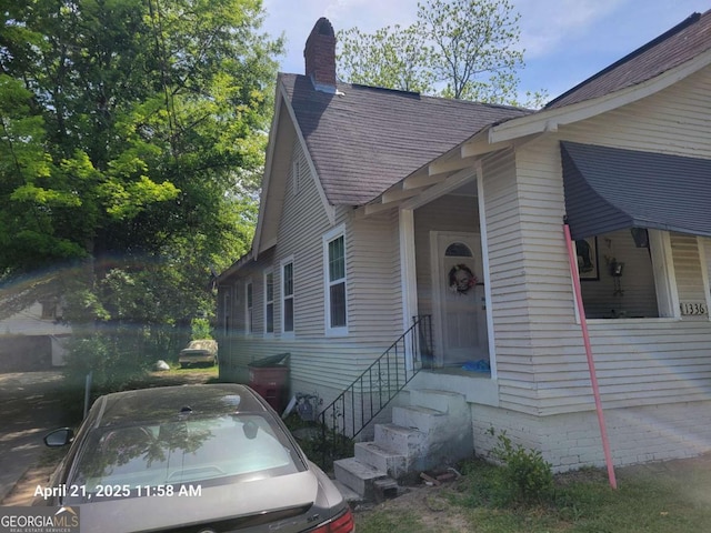 1336 Winton Ave, Macon, GA 31204 - view of front of home with roof with shingles and a chimney