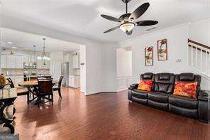 121 Royal Sunset Dr, Dallas, GA 30157 - living area with a ceiling fan, wood finished floors, and stairway