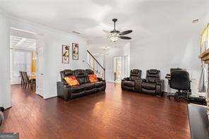 121 Royal Sunset Dr, Dallas, GA 30157 - living area with stairway, wood finished floors, and ceiling fan