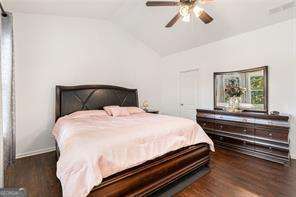 121 Royal Sunset Dr, Dallas, GA 30157 - bedroom featuring wood finished floors, vaulted ceiling, and ceiling fan