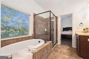 121 Royal Sunset Dr, Dallas, GA 30157 - ensuite bathroom with vanity, a bath, a shower stall, and tile patterned floors
